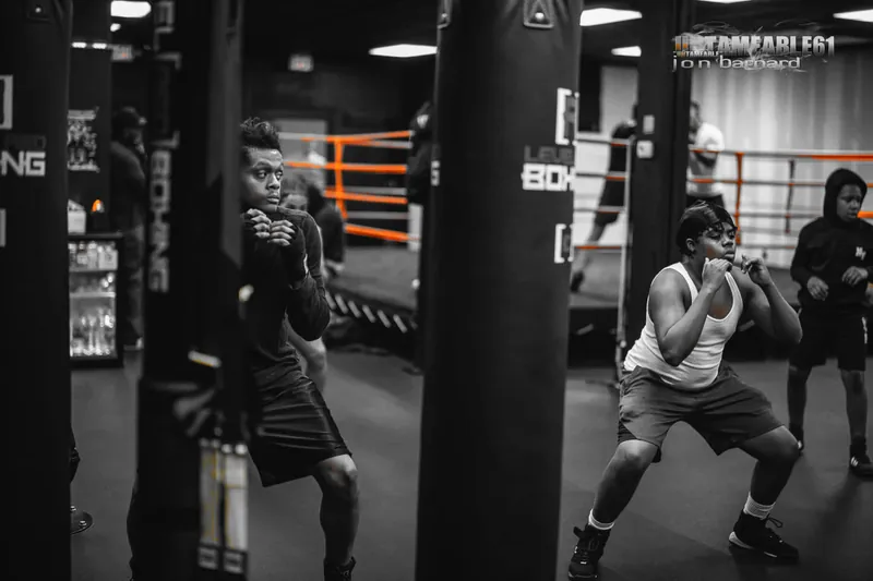 Teen boxers between the heavy bags