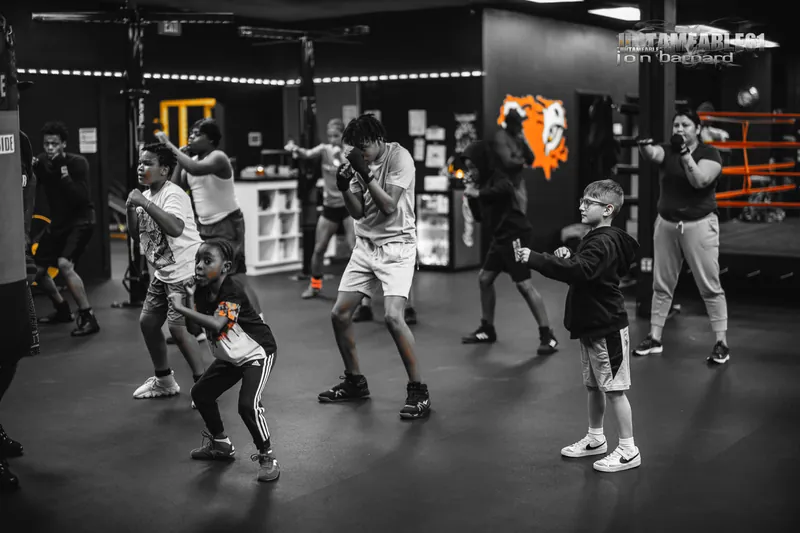 A full class in stance under the tiger mural